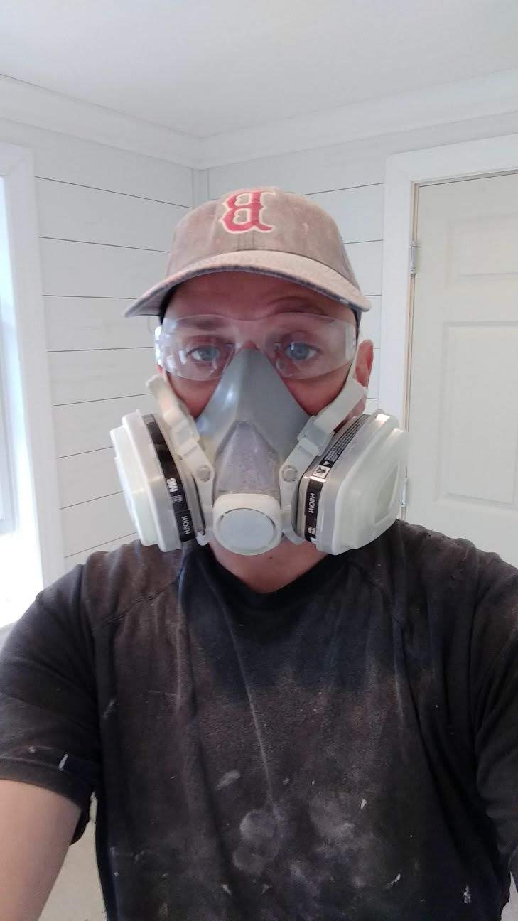 Pia Painting crew member wearing proper respirator and safety gear
